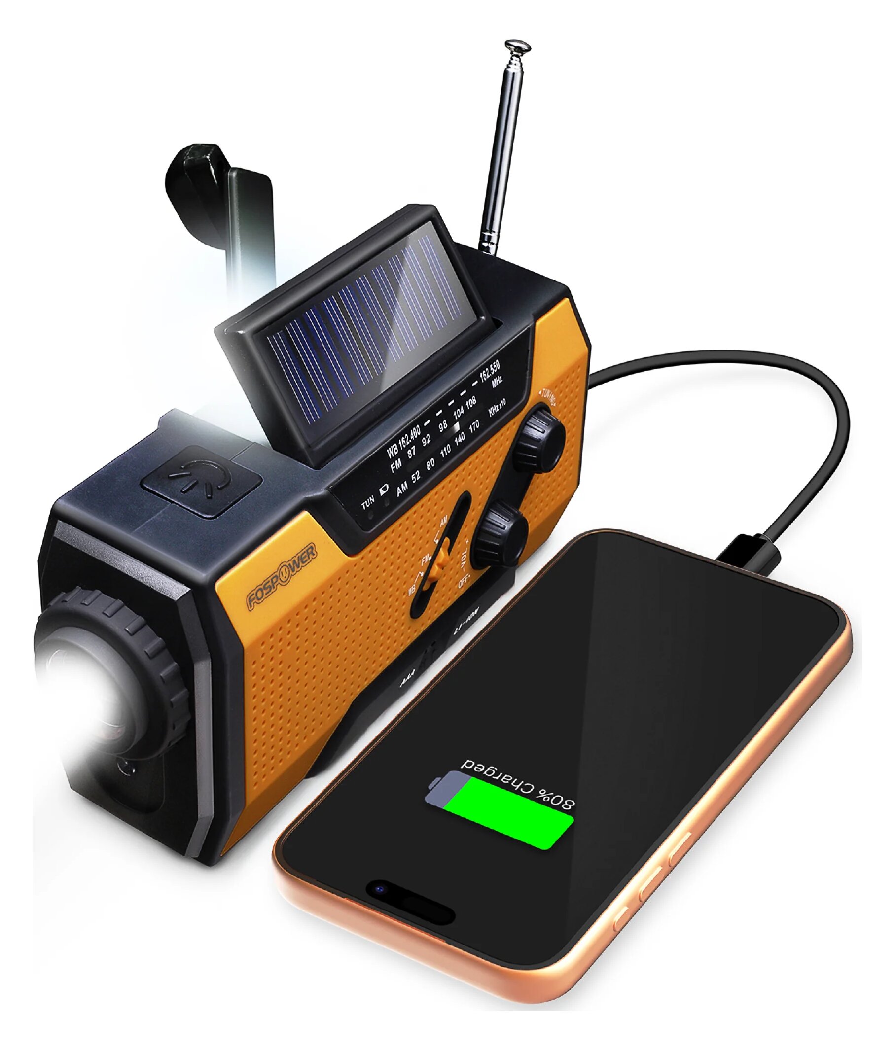 An orange and black FosPower A1 radio with its solar panel tilted up, an extended antenna and a crank, with a phone charging from it by cable