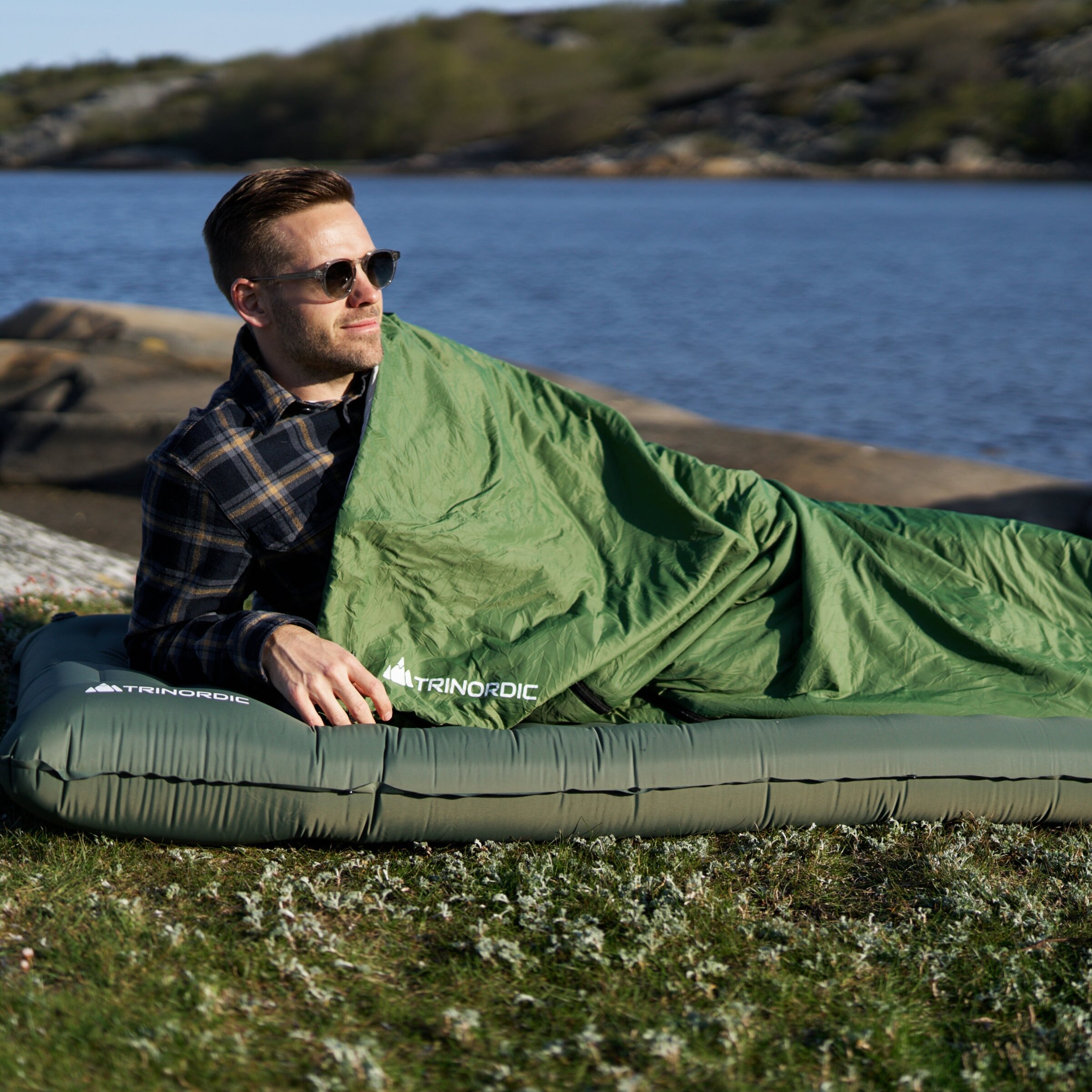 Green Trinordic Somra EN sleeping bag on a sleeping pad in a tent